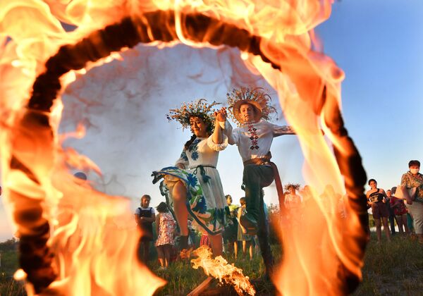 دختر و پسری در حال پریدن از حلقه آتش در جشن ایوان کوپال در بلاروس - اسپوتنیک ایران  