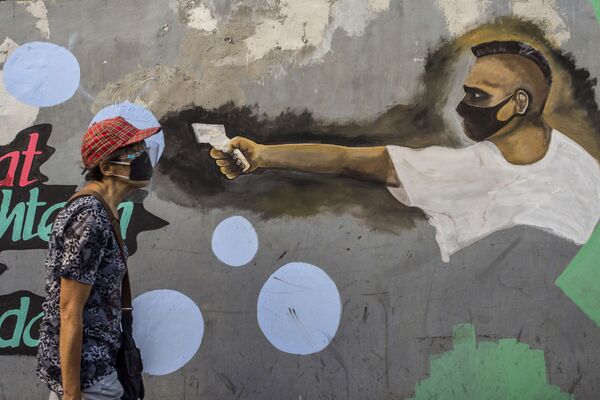 گرافیتی مردی با تب سنج در جزیره جاوه اندونزی - اسپوتنیک ایران  