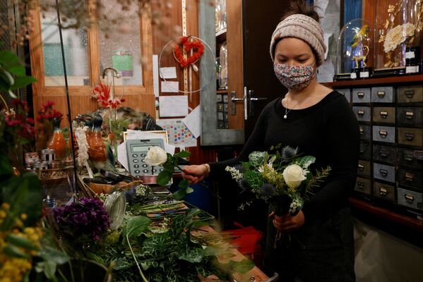 فروشنده گل با ماسک در روز ولنتاین در پاریس، فرانسه - اسپوتنیک ایران  