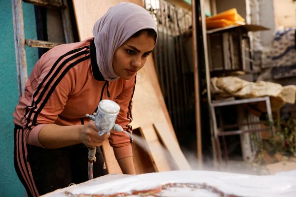 نور الجانبی، دختر عراقی 28 ساله در بغداد نجاری می کند. او در حال رنگ زدن تخته هاست. - اسپوتنیک ایران  