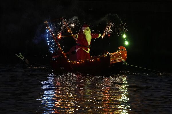 مردی که لباس بابا نوئل به تن دارد، روی یک قایق در ایمپریا، نزدیک جنوا، ایتالیا24 دسامبر 2022 - اسپوتنیک ایران  