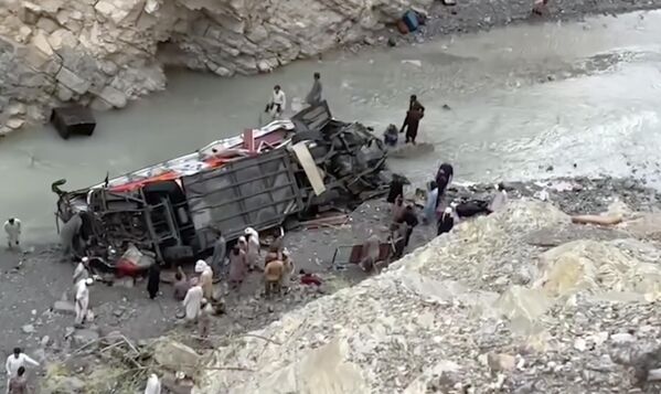 نیروهای امدادی در حال جستجوی بازماندگان در لاشه اتوبوس مسافربری که از جاده کوهستانی به دره عمیقی در دانا سر، استان خیبر پختونخوا، در جنوب غربی پاکستان سقوط کرد ، یکشنبه، 3 ژوئیه 2022 - اسپوتنیک ایران  