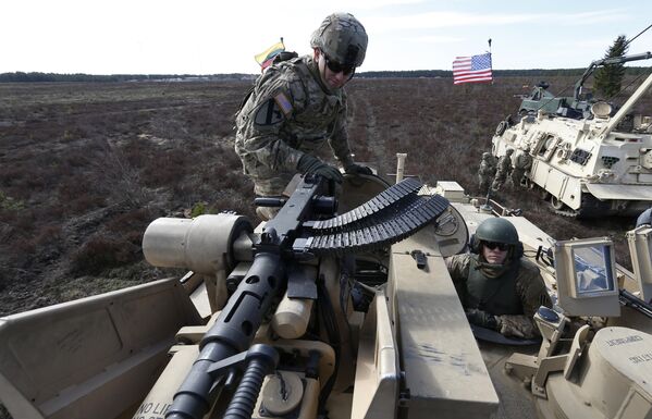 سربازان آمریکایی از گردان دوم، تیم رزمی تیپ 1، لشکر 3 پیاده نظام بر روی یک تانک رزمی M1A2 آبرامز در طی یک تمرین نظامی در محدوده آموزشی Gaiziunu در پابراد در حدود 60 کیلومتری (38 مایل) شمال پایتخت ویلنیوس، لیتوانی، پنجشنبه 9 آوریل ، 2015. ایالات متحده آمریکا از آوریل 2014 حضور مداوم نیروهای زمینی در حال چرخش را در قلمرو  کشورهای بالتیک و لهستان حفظ کرده است. (AP عکس از/Mindaugas Kulbis) - اسپوتنیک ایران  