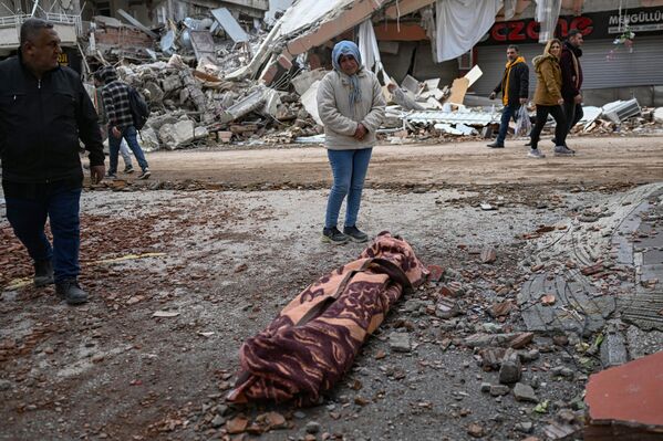 زنی در کنار جسد قربانی در هاتای. - اسپوتنیک ایران  