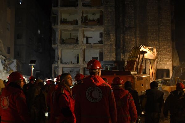 امدادگران در 8 فوریه 2023، دو روز پس از زمین لرزه مرگبار سوریه و ترکیه، در میان آوارهای ساختمان فروریخته در شهر حلب در شمال سوریه در حال  جستجوی بازماندگان هستند. - اسپوتنیک ایران  
