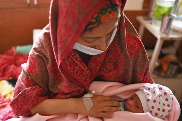 این عکس که در 25 آوریل 2023 گرفته شده است، مانو بالا را نشان می دهد که دختر تازه متولد شده خود را در یک بخش زایمان یک بیمارستان  در دهرا، در منطقه کانگرا در ایالت هیماچال پرادش هند در آغوش گرفته است. - اسپوتنیک ایران  