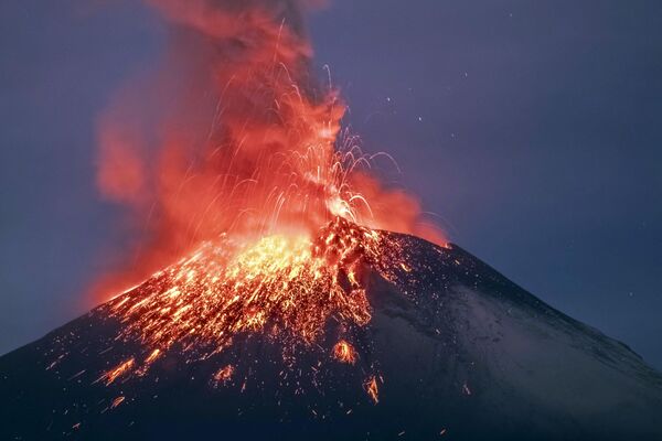 فوران آتشفشان پوپوکاتپتل در سن نیکولاس د لس رانچوس، مکزیک.آتش فرو ریخته از دهانه کوه، دامنی تماشایی را به تصویر می کشد که تماس با آن سوزان و کشنده است. - اسپوتنیک ایران  