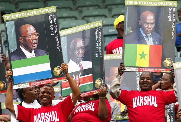 آفریقای جنوبی پوسترهای رؤسای جمهور آفریقا را در 9 ژوئیه 2002 در استادیومی در دوربان در جریان راه اندازی رسمی اتحادیه آفریقا بالا می برد.اولین جلسه 53 عضو اتحادیه آفریقا، که جایگزین سازمان وحدت آفریقا می شود، توسط تابو امبکی، رئیس جمهور آفریقای جنوبی، که برای اولین سال ریاست این نهاد جدید پان آفریقایی را بر عهده خواهد داشت، افتتاح شد. اتحادیه آفریقا از اتحادیه اروپا الگوبرداری شده است و پیشنهاد ایجاد یک شورای صلح و امنیت آفریقا، یک پارلمان آفریقا، یک دادگاه مشترک عدالت، بانک مرکزی و واحد پول واحد را دارد. - اسپوتنیک ایران  