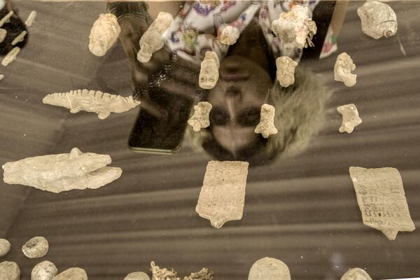 توجه یکی از بازدیدکنندگان به پانل کشف شده در یک مقبره باستانی تازه کشف شده در گورستان ساقارا در جنوب قاهره، جایی که باستان شناسان دو کارگاه مومیایی کردن انسان و حیوانات و همچنین دو مقبره را کشف کردند. - اسپوتنیک ایران  