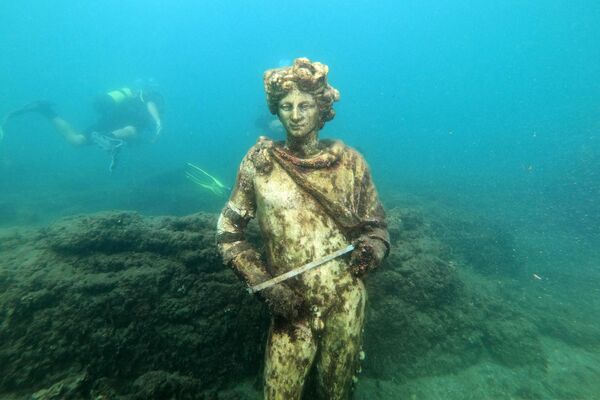 یک غواص کپی مجسمه منحصربفردی در شهر باستانی زیر آب رفته  بایلی روم قدیم را در ایتالیا به گردشگران نشان می دهد - اسپوتنیک ایران  