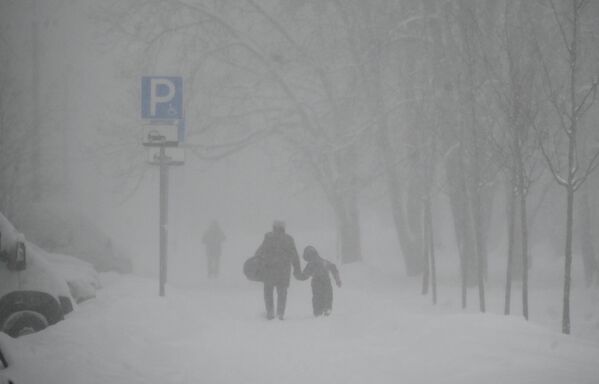 پدر و کودکی در یکی از خیابان های مسکو که ارتفاع برف به 28 تا 33 سانتیمتر رسیده بود. - اسپوتنیک ایران  
