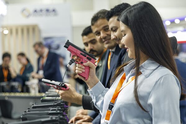 بازدیدکننده ای از قزاقستان در روز افتتاحیه سومین دوره نمایشگاه دفاعی مصر (ایدکس-2023)، با حضور 111 کشور شرکت کننده، در مرکز نمایشگاه های بین المللی قاهره، درمصر، یک اسلحه را آزمایش می کند. - اسپوتنیک ایران  