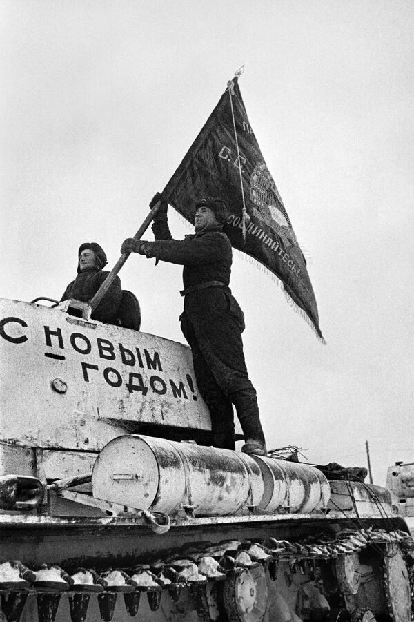 یک تانکیست پرچم  واحد نظامی خود را روی یک تانک قرار می دهد. تانکیست ها به جبهه می روند. دفاع از مسکو. 31 دسامبر 1941. - اسپوتنیک ایران  
