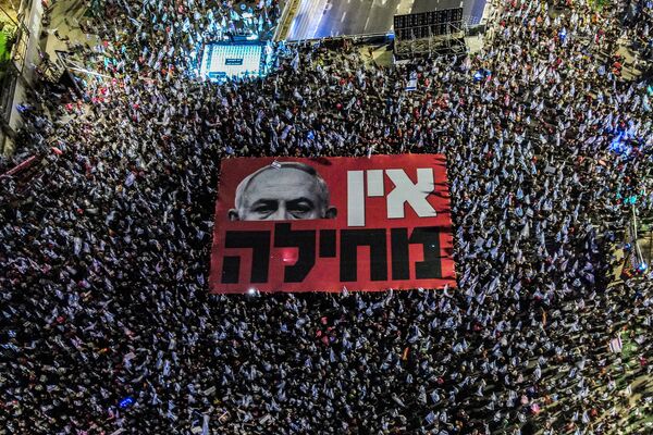 تظاهرکنندگان در حال باز کردن یک بنر بزرگ علیه بنیامین نتانیاهو، نخست وزیر اسرائیل در جریان تظاهرات علیه طرح بازنگری قضایی دولت اسرائیل در نزدیکی مرکز خرید آزریلی در تل آویو در 23 سپتامبر 2023. - اسپوتنیک ایران  