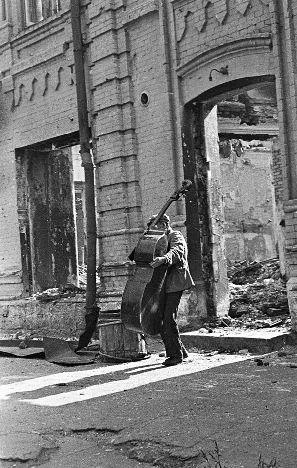 جنگ بزرگ میهنی 1941-1945 . نبرد استالینگراد. یک نوازنده در خیابان شهر ویران شده استالینگراد. - اسپوتنیک ایران  