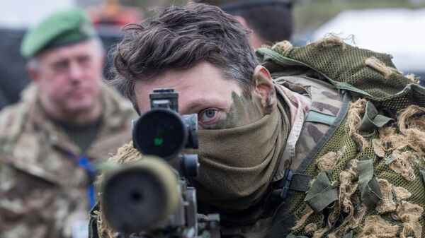 A British soldier looks into a telescopic sight as he holds his sniper rifle during the NATO DRAGON-24 military exercise in Korzeniewo, northern Poland - اسپوتنیک ایران  