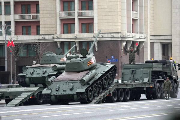 پرسنل نظامی تانک های T-34-85 را در ستونی از تجهیزات نظامی قبل از تمرین برای رژه به افتخار هفتاد و نهمین سالگرد پیروزی در جنگ بزرگ میهنی تخلیه می کنند. - اسپوتنیک ایران  