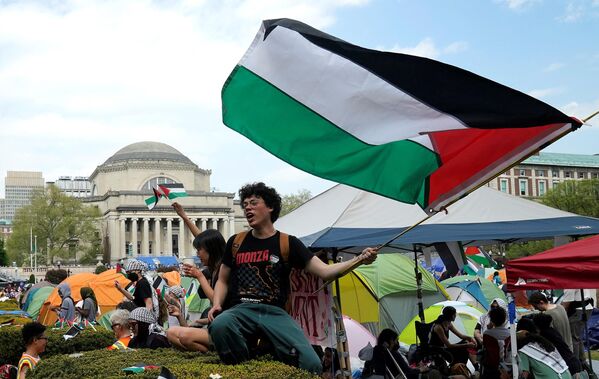 معترضان پرچم های فلسطین را در زمین چمن غربی دانشگاه کلمبیا در 29 آوریل 2024 در نیویورک به اهتزاز در می آورند. دانشجویان تظاهرکننده در دانشگاه کلمبیا، مرکز تظاهرات طرفداران فلسطینی که در تمام کالج‌های ایالات متحده آغاز شده است، روز دوشنبه گفتند که تا زمانی که دانشگاه به خواسته‌های آنها رسیدگی ، تسلیم نخواهند شد، و از اولتیماتوم برای متفرق شدن یا تعلیق سرباز زدند. - اسپوتنیک ایران  