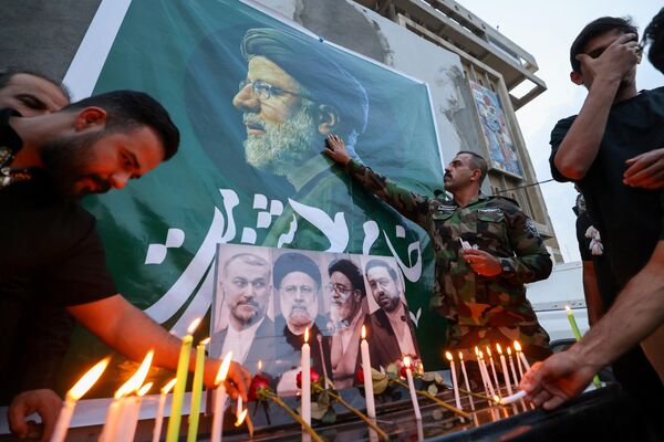 عراقی ها در عراق به یاد ابراهیم رئیسی رئیس جمهور فقید ایران شمع روشن می کنند. - اسپوتنیک ایران  
