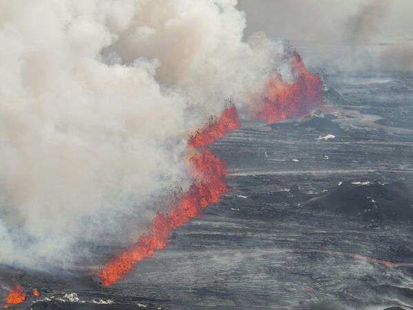  فوران گدازه و دود از آتشفشانی در گرینداویک، ایسلند، چهارشنبه، 29 مه 2024 . کوه آتشفشان در جنوب غربی ایسلند روز چهارشنبه برای پنجمین بار از ماه دسامبر فوران کرد و گدازه های قرمز رنگی به بیرون پرتاب کرد که بار دیگر شهر ساحلی گرینداویک را تهدید کرد و منجر به تخلیه مردم از آبگرم ژئوترمال محبوب Blue Lagoon شد. - اسپوتنیک ایران  