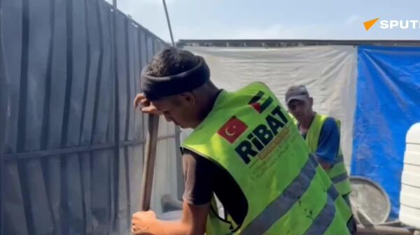 روایت تصویری از فعالیت های یک سازمان خیریه برای تحویل غذا به ساکنان غزه - اسپوتنیک ایران  