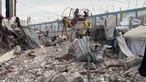 کودکان غزه در حال بازی در میان ویرانه‌های ساختمان‌های نوار غزه که بر اثر جنگ ویران شده‌اند - اسپوتنیک ایران  