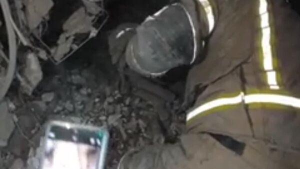 بیرون آوردن پیکر بی‌جان دختربچه یکساله از زیر آوار یک منزل مسکونی در تهران پس از اصابت موشک‌های آمریکایی اسرائیلی - اسپوتنیک ایران  