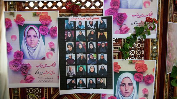 Portraits of school children from the Shajarah Tayyebeh Elementary School in Minab, who were killed in a U.S strike are displayed during a press conference by Iranian Ambassador to Tunisia Massoud Hosseinian, in Tunis, Tunisia, Thursday, March 12, 2026. (AP Photo/Ons Abid) - اسپوتنیک ایران  