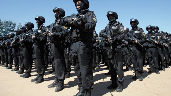 SWAT members of the Beijing Municipal Public Security Bureau stand in formation after conducting a joint anti-terrorism at a training ground on the outskirts of Beijing - اسپوتنیک ایران  