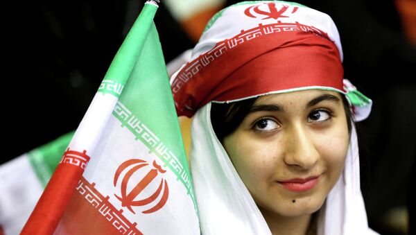 Iranian woman holds an Iranian flag during a ceremony of farewell for the national soccer team - اسپوتنیک ایران  