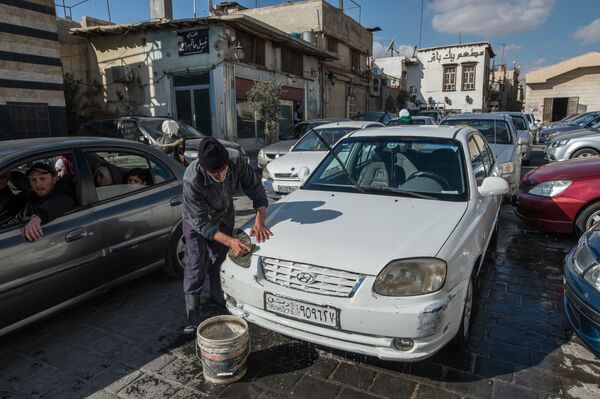 مردی خودرویی را در محله باب شرقی  دمشق می شوید - اسپوتنیک ایران  