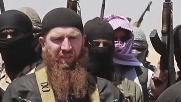 Omar al-Shishani standing next to the group's spokesman among a group of fighters as they declare the elimination of the border between Iraq and SyriaDaesh leader Abu Omar al-Shishani. (File) - اسپوتنیک ایران  