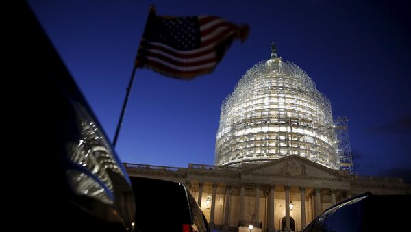 A U.S. flag on a vehicle flutters as the sun sets behind the U.S. Capitol dome in the hours before President Barack Obama delivers the State of the Union address to a joint session of Congress in Washington January 12, 2016 - اسپوتنیک ایران  