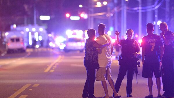 Orlando Police officers direct family members away from a multiple shooting at a nightclub in Orlando, Fla., Sunday, June 12, 2016 - اسپوتنیک ایران  