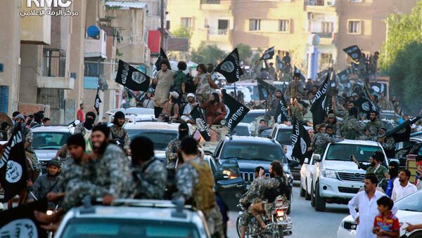 In this undated file image posted on Monday, June 30, 2014, by the Raqqa Media Center of the Islamic State group, a Syrian opposition group, which has been verified and is consistent with other AP reporting, fighters from the Islamic State group parade in Raqqa, north Syria - اسپوتنیک ایران  