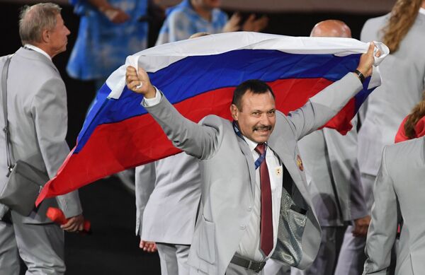 آندری فوموچکین، نماینده هیأت بلاروسی با پرچم روسیه  در زمان رژه ورزشکاران  و  اعضای  تیم های ملی  در  مراسم گشایش  15 –مین  بازی های  تابستانی پاراالمپیک 2016 در ریو د ژانیرو - اسپوتنیک ایران  