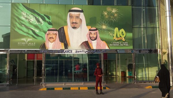 FILE -- In this Dec. 14, 2015 file photo, images of King Salman, center, Crown Prince Mohammed bin Nayef , left, and Deputy Crown Prince Mohammed bin Salman hang at the entrance of a shopping center in Riyadh, Saudi Arabia to mark the country's 85th anniversary - اسپوتنیک ایران  