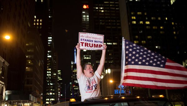 A supporter of U.S. Republican presidential candidate Donald Trump cheers near the intersection of West 54th Street and Fifth Avenue in New York, U.S. November 9, 2016 - اسپوتنیک ایران  