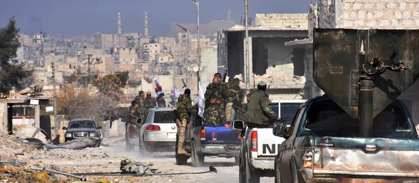 Syrian pro-government forces patrol Aleppo's Sheikh Saeed district, on December 12, 2016, after troops retook the area from rebel fighters - اسپوتنیک ایران  