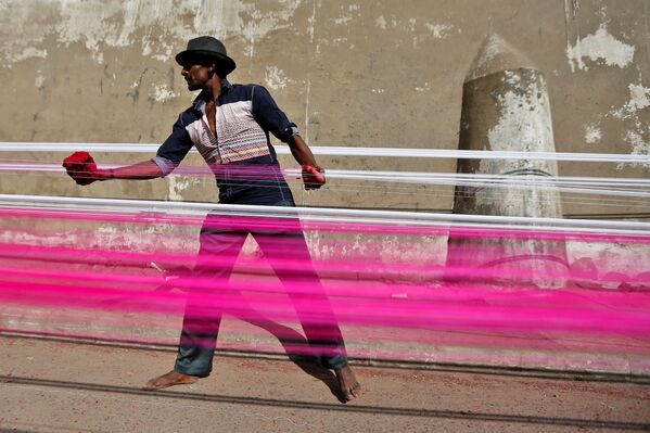 کارگر هندی در حال  رنگ کردن نخ ها برای بادبادک در احمد آباد هند - اسپوتنیک ایران  