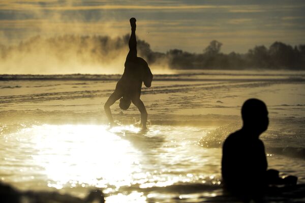 اعضای باشگاه « دوستداران شنای زمستانی نوگورود» در حال شنا در رودخانه « ولخوف» روسیه - اسپوتنیک ایران  