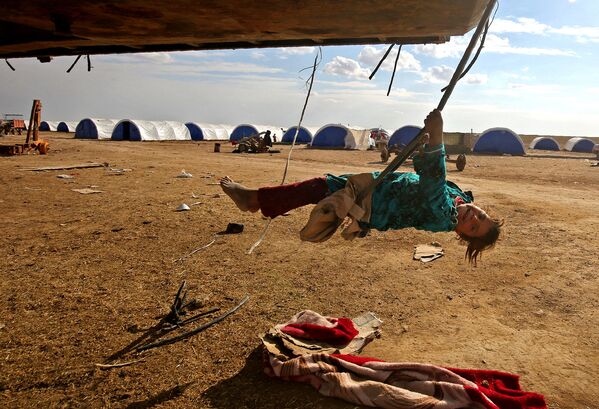 دختری در حال تاب بازی در اردوگاه پناهجویان در جنوب – شرق موصل - اسپوتنیک ایران  