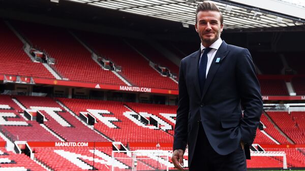 Former Manchester United and England footballer David Beckham poses on the pitch at Old Trafford in Manchester, north west England on October 6, 2015 ahead of a charity football match in aid of UNICEF - اسپوتنیک ایران  