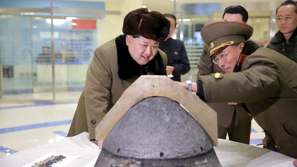 North Korean leader Kim Jong Un looks at a rocket warhead tip after a simulated test of atmospheric re-entry of a ballistic missile, at an unidentified location in this undated file photo released by North Korea's Korean Central News Agency (KCNA) in Pyongyang on March 15, 2016. - اسپوتنیک ایران  
