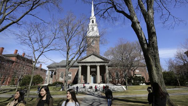 In this Sunday, March 13, 2016, photo people walk near Memorial Church, behind, on the campus of Harvard University, in Cambridge, Mass. Amid scrutiny from Congress and campus activists, colleges across the country are under growing pressure to reveal the financial investments made using their endowments. - اسپوتنیک ایران  