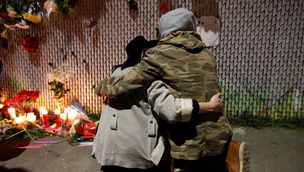 Пара у импровизированного мемориала погибшим при пожаре на складе в Окленде, США - اسپوتنیک ایران  