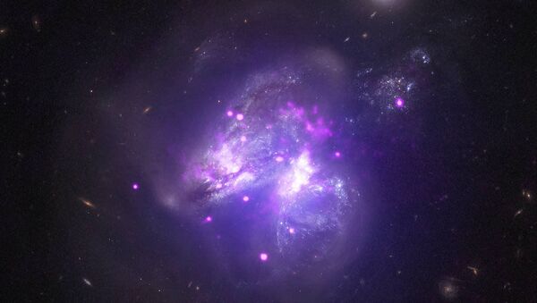 Сливающиеся галактики Arp 299, снятые телескопом Чандра - اسپوتنیک ایران  