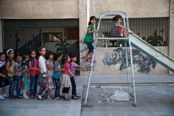 دانش آموزان هنگام بازی در حیاط مدرسه ای نزدیک دمشق سوریه - اسپوتنیک ایران  