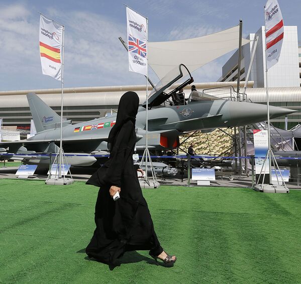 دختری در حال عبور از کنار جنگندهEurofighter Typhoon در نمایشگاهIDEX  در امارات متحده عربی - اسپوتنیک ایران  