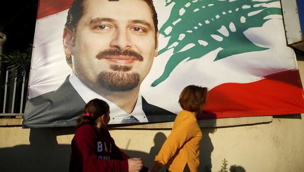 A woman and her daughter pass by a poster of outgoing Prime Minister Saad Hariri, in Beirut, Lebanon, Saturday, Nov. 11, 2017. Lebanon's president has called on Saudi Arabia to clarify the reasons why the country's prime minister has not returned home since his resignation which was announced from the kingdom - اسپوتنیک ایران  